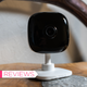 A photo of the Kasa Spot camera standing on wood